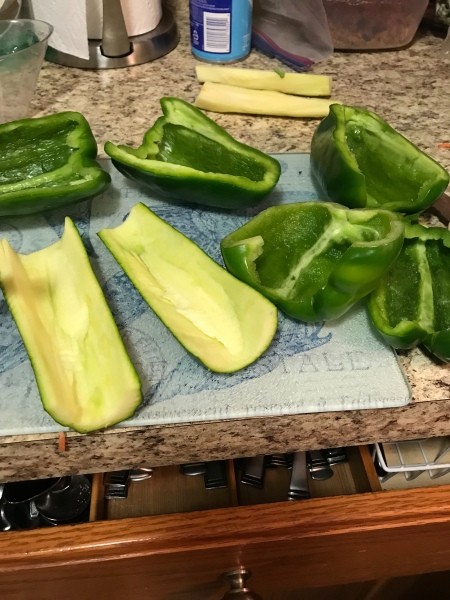 Halved and seeded zucchini and peppers.