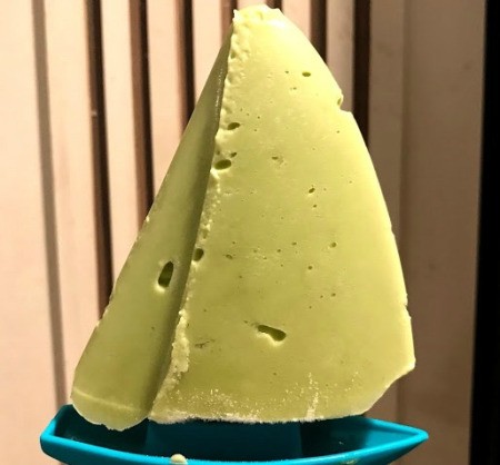 An avocado popsicle shaped like a boat.