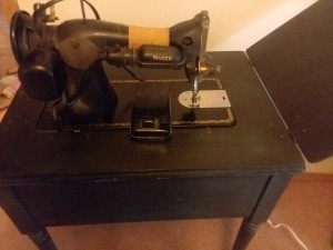 Value and Age of a Vintage Singer Sewing Machine - looking down on the back side of a sewing machine in a cabinet