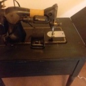 Value and Age of a Vintage Singer Sewing Machine - looking down on the back side of a sewing machine in a cabinet