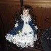 Value of an Ashley Belle Doll - doll wearing a white lacy dress with a dark blue overskirt