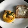 Baked Egg in a Tomato on plate with bread slice