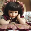 Identifying a Porcelain Doll - doll in gingham dress lying on tummy and propped up on elbows