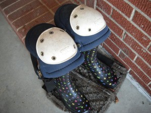 Knee pads on top of rubber boots for garden work.