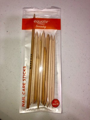 A package of cuticle sticks with one made from a bamboo skewer.