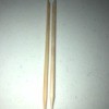 A homemade bamboo cuticle stick next to a store bought one.