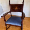 Identifying an Antique Rocker - dark wood rocking chair with decorative design on backrest and tall finials