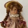 Identifying a Porcelain Doll -doll with braids and a straw hat