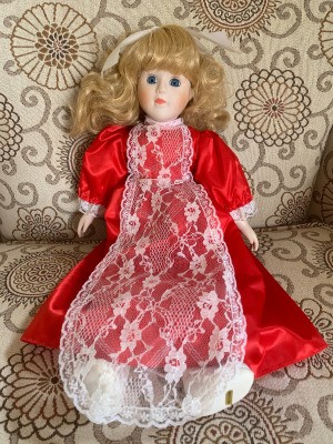 Identifying a Porcelain Doll - doll in red dress with lace apron