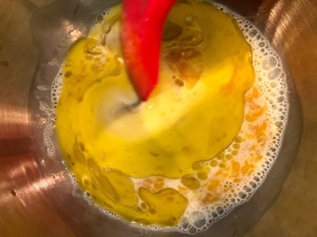 mixing milk & eggs to bowl