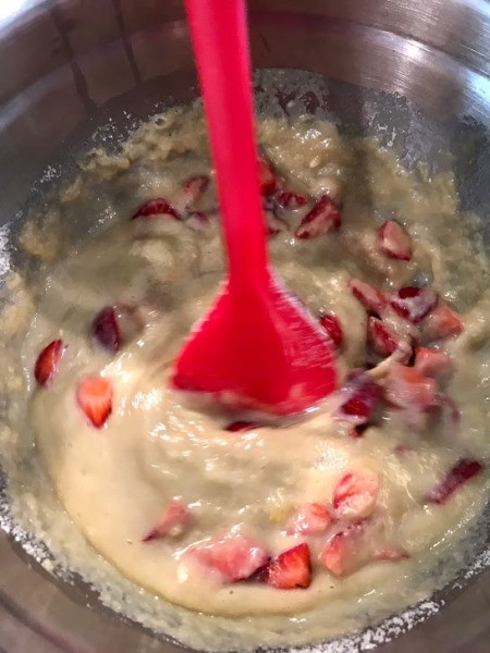 adding strawberries to batter