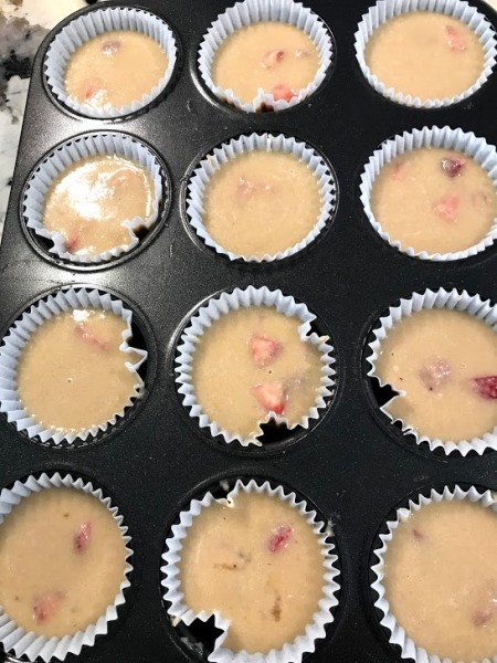 adding batter to muffin tins