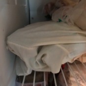 A pillowcase full of corn in the freezer.