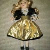Selling Porcelain Dolls - doll in gold and black short fancy dress