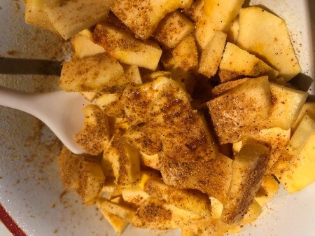 mixing Acorn Squash Fries with seasoning