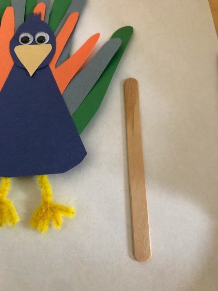 Peacock Popsicle Stick Puppet - feet taped on