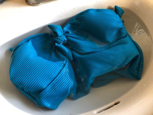 How to Care for Your Swimwear - suit soaking in vinegar water