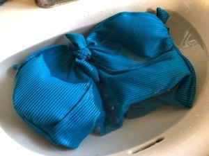 How to Care for Your Swimwear - suit soaking in vinegar water