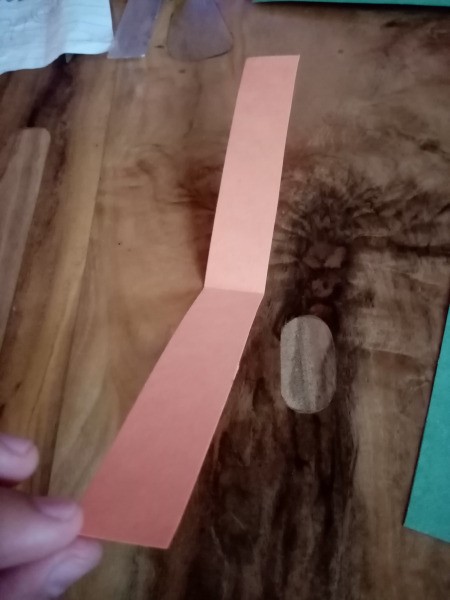 Making a Paper Worm Race Game - strip of paper folded in half and opened