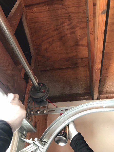 Lubricating a garage door high up.