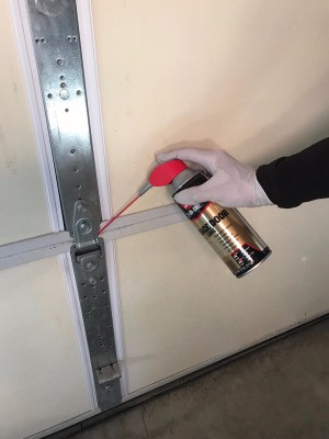 Lubricating a garage door.