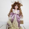 Value of a Collectible Memories Porcelain Doll - doll with long red hair wearing a period ecru lace and lavender satin dress and hat