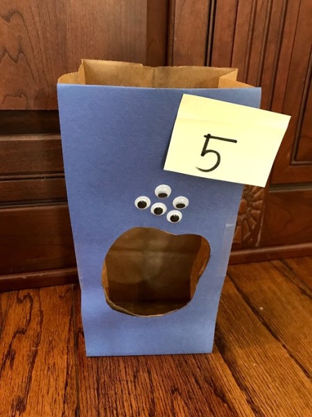 Feed the Monster Math Game - place the sticky note with your total on the bag