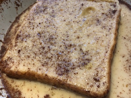dipping bread in egg cinnamon mixture