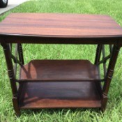 Value of a Brandt Site Table - rectangular table with decorative sides and slanted lower shelf