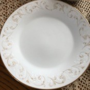 Value of Noritake China - white plate with a gold and white scroll pattern