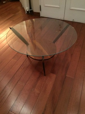 Value of a Vintage Round Glass Topped Table - round glass topped table with wood base including a shelf and three legs