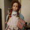 Identifying a Vanessa Porcelain Doll - doll with braids, a striped dress and white lace edged, embroidered apron