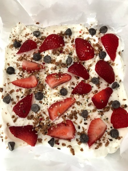 yogurt sprinkled with strawberries, blueberries & hemp seeds