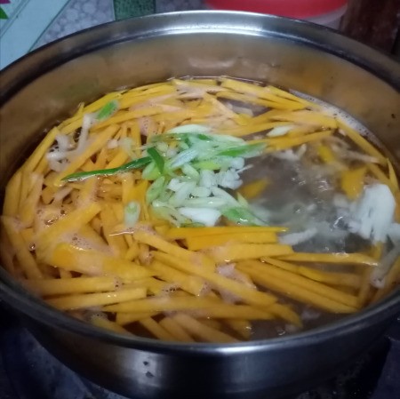 adding vegetables to boiling water