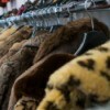 A row of faux fur jackets.