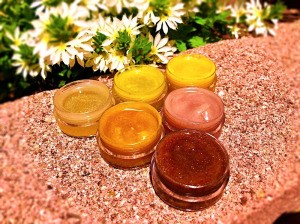 How to Make Natural Tinted Lip Balm - open containers of 6 shades of lip balm