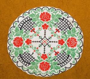 A colorful cross stitched circle.