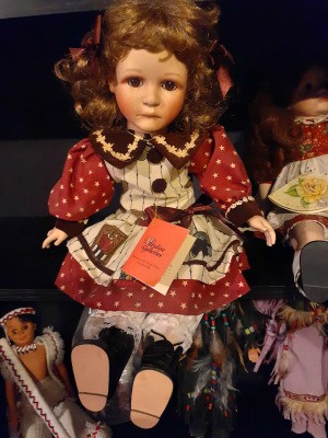 Value of a Paradise Galleries Porcelain Doll - doll wearing a red, white, and blue dress