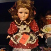 Value of a Paradise Galleries Porcelain Doll - doll wearing a red, white, and blue dress