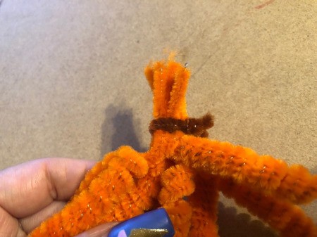 Pipe Cleaner Pumpkin Craft - wrap a short piece of a brown pipe cleaner around the gathered ends of the orange pipe cleaners
