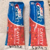 Two tubes of toothpaste with names marked on them.