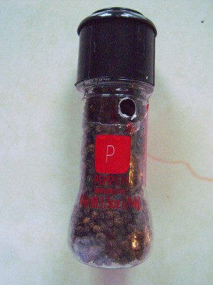 A peppe rmill with a small hole in it, to let out the peppercorns.