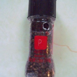 A peppe rmill with a small hole in it, to let out the peppercorns.