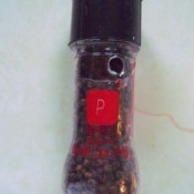 A peppe rmill with a small hole in it, to let out the peppercorns.