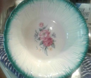 Value of a Homer Laughlin Serving Bowl  - white bowl with rose pattern in the center and teal  edge merging with the white background