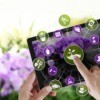 An online nursery app in front of purple flowers.