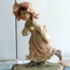 Value of an Armani Figurine - figurine of a little girl wearing a long dress and ruffled brimmed hat running