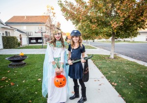 Two tween girls trick or treating.