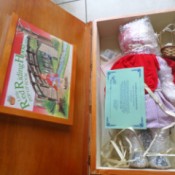 Value of  Fairytale Collection Porcelain Dolls - Red Riding Hood doll still wrapped in plastic in a wood box