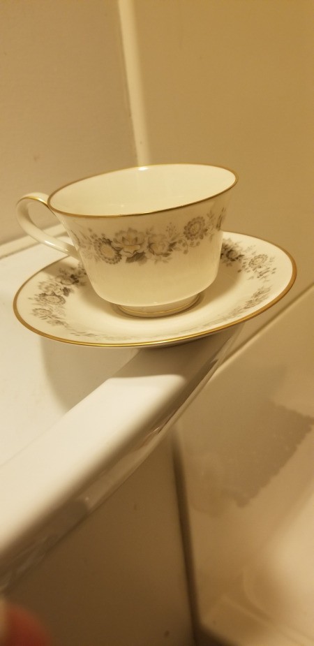 Finding the Value of Crown Victoria Tea Cup - cup and saucer with a floral pattern and gold rims